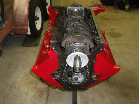 1957 Ford Custom Sedan - Close-up view of a red engine block, revealing the crankshaft and timing chain assembly.