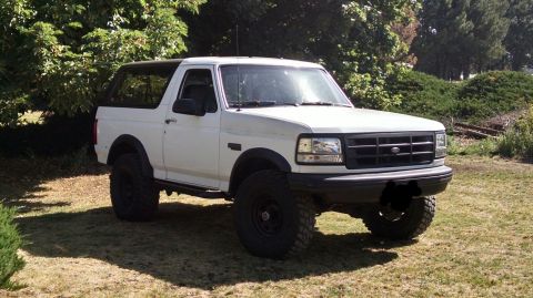 1992 Ford Bronco - This 1992 Ford Bronco is shown from a three-quarter front view, parked outdoors on a grassy area.