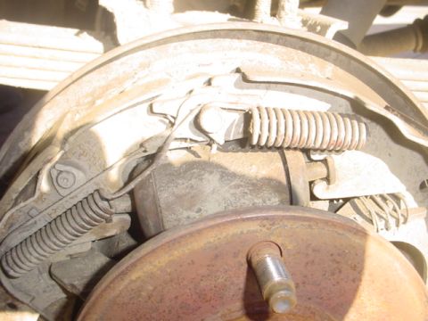 1988 Ford Bronco - Drum brake assembly showing springs and brake shoes, with a SuperMotors.net watermark.