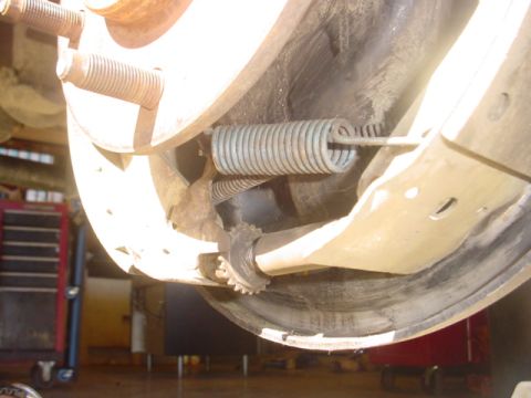 1988 Ford Bronco - Detail of a vehicle's brake drum and spring assembly, showing internal components and signs of use.