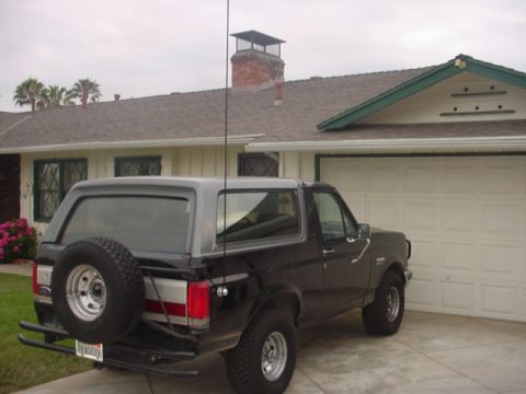 1988 Ford Bronco - Rear 3/4 view of a black 1988 Ford Bronco with a spare tire mounted on the back.