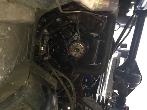 1994 Ford Bronco - The underside of a 1994 Ford Bronco shows the transmission bell housing and part of the rear differential. The vehicle is viewed from below…