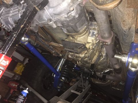 1994 Ford Bronco - Underside view of a vehicle, likely a 1994 Ford Bronco, showing the transmission, exhaust system, and suspension components. The vehicle is…