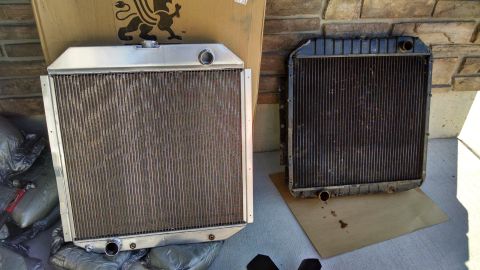 1979 Ford F-150 - A new aluminum radiator is shown next to an older, dirty radiator, likely for a 1979 Ford F-150. The radiators are placed on a concrete sur…