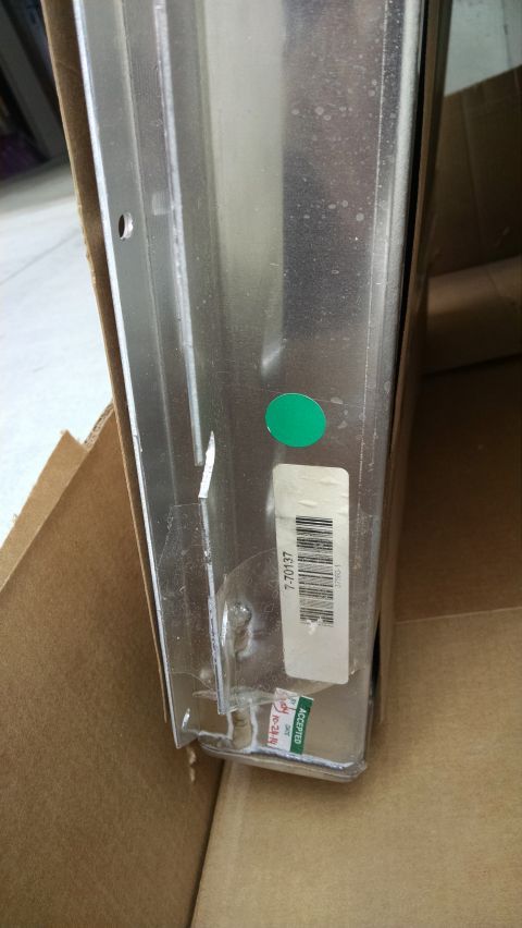 1979 Ford F-150 - A close-up view of a metal part with a barcode sticker and an "ACCEPTED" stamp with the date "10-24-14". A green circular sticker is also v…