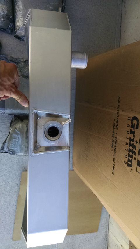 1979 Ford F-150 - A silver aluminum radiator is shown next to a cardboard box with the Griffin Radiator logo and address. A hand is pointing to the radiator'…