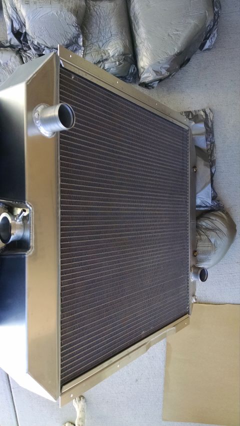 1979 Ford F-150 - Aluminum performance radiator with multiple hose necks, photographed lying on packing material.