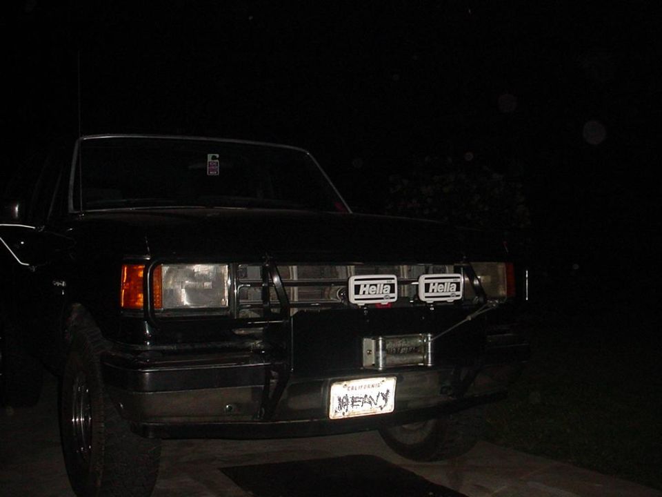 Black truck front view with Hella lights and winch