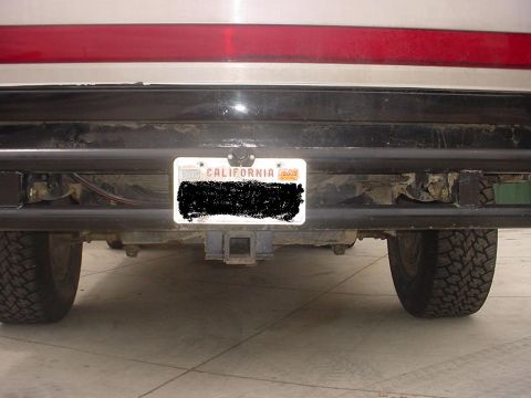 1988 Ford Bronco - The rear of an SUV is shown, a trailer hitch and a California license plate.