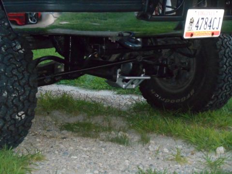 1994 Ford Bronco - The rear axle and suspension of a modified SUV are visible, featuring a custom tow hitch and BFGoodrich tires. A Virginia license plate rea…