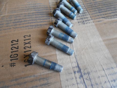 1992 Ford Bronco - Several hex head bolts with blue threadlocker are laid out on a brown cardboard surface. Text printed on the cardboard reads "#161212 1CX12…