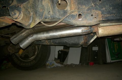 1981 Ford Bronco - Close-up of a vehicle's undercarriage, focusing on the exhaust system and a recently welded pipe.