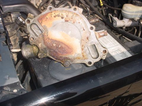 1988 Ford Bronco - A corroded water pump is shown removed from its engine assembly.