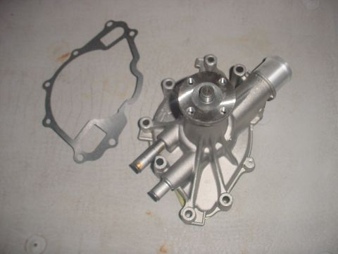 1988 Ford Bronco - A silver water pump and its gasket are shown on a flat surface, ready for installation.
