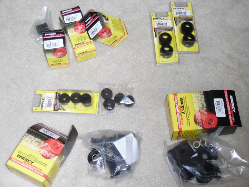 Energy Suspension polyurethane bushing kits and loose black bushings on carpet