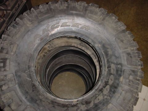 1988 Ford Bronco - A stack of Goodyear Wrangler tires is shown, with the brand name visible on the sidewall.