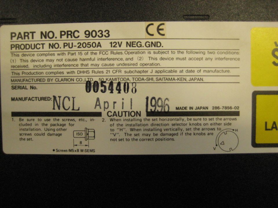 Close-up of a product label with part numbers, serial number, and manufacturing date.