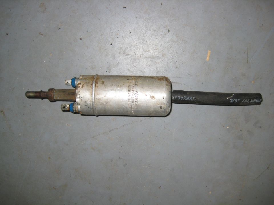 Bosch fuel pump with black hose attached on concrete