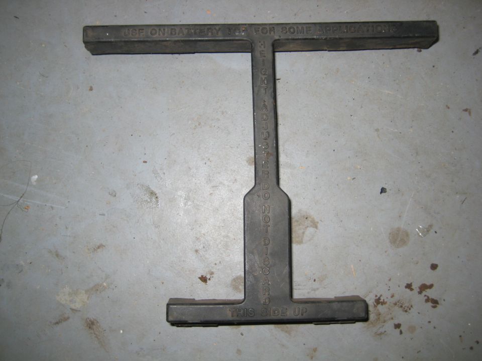 Black I-shaped tool with text on a concrete floor.