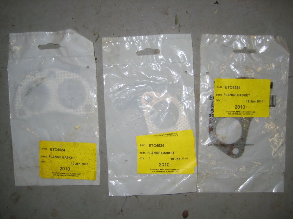 Three packaged flange gaskets with yellow labels on a concrete floor.