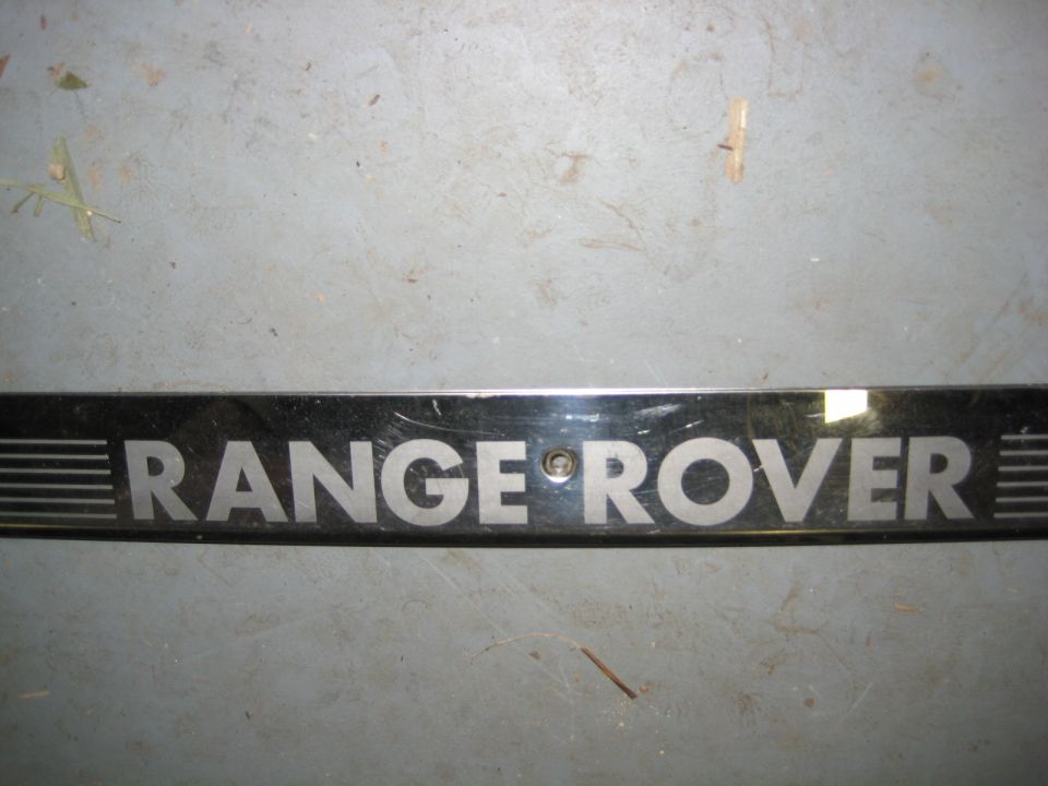Chrome Range Rover trim piece with silver lettering.