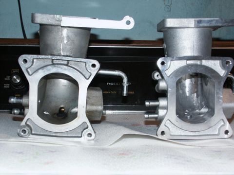 2001 Mercury Grand Marquis - Two throttle bodies are shown, possibly for comparison or modification. One appears to be modified with a white tab.
