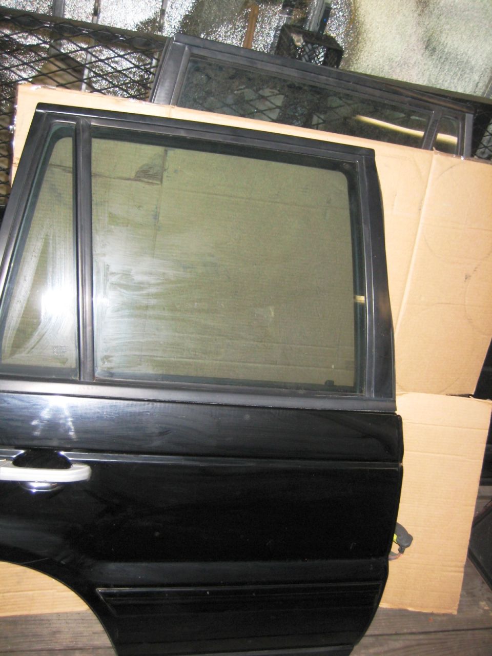 Black Range Rover rear door with chrome handle and tinted window