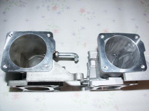2001 Mercury Grand Marquis - Two intake plenums are shown side-by-side against a floral background.