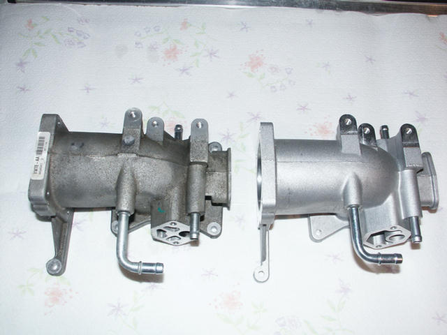 Two aluminum intake manifolds, one used and one cleaned/refurbished
