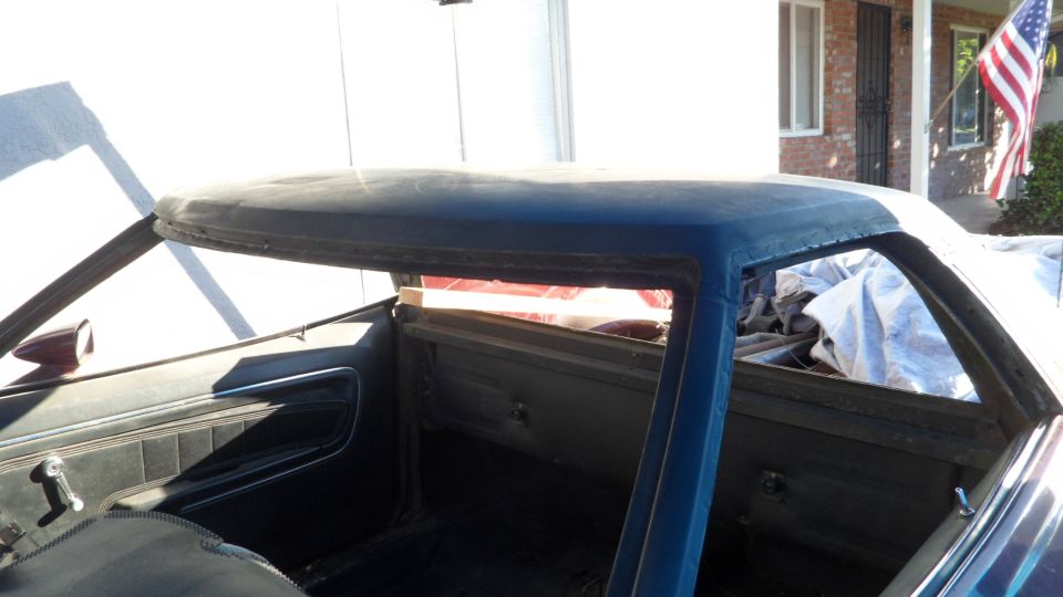 Interior view of a classic Ford Ranchero with roofline and door panels visible.