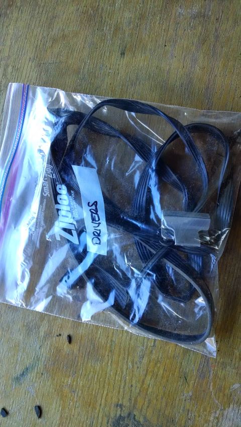1992 Ford Bronco - A clear plastic Ziploc bag containing black cables and a label that reads "DRIVERS". The bag is placed on a wooden surface.