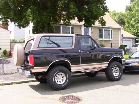 1996 Ford Bronco - This 1996 Ford Bronco is parked on a residential street next to another vehicle.