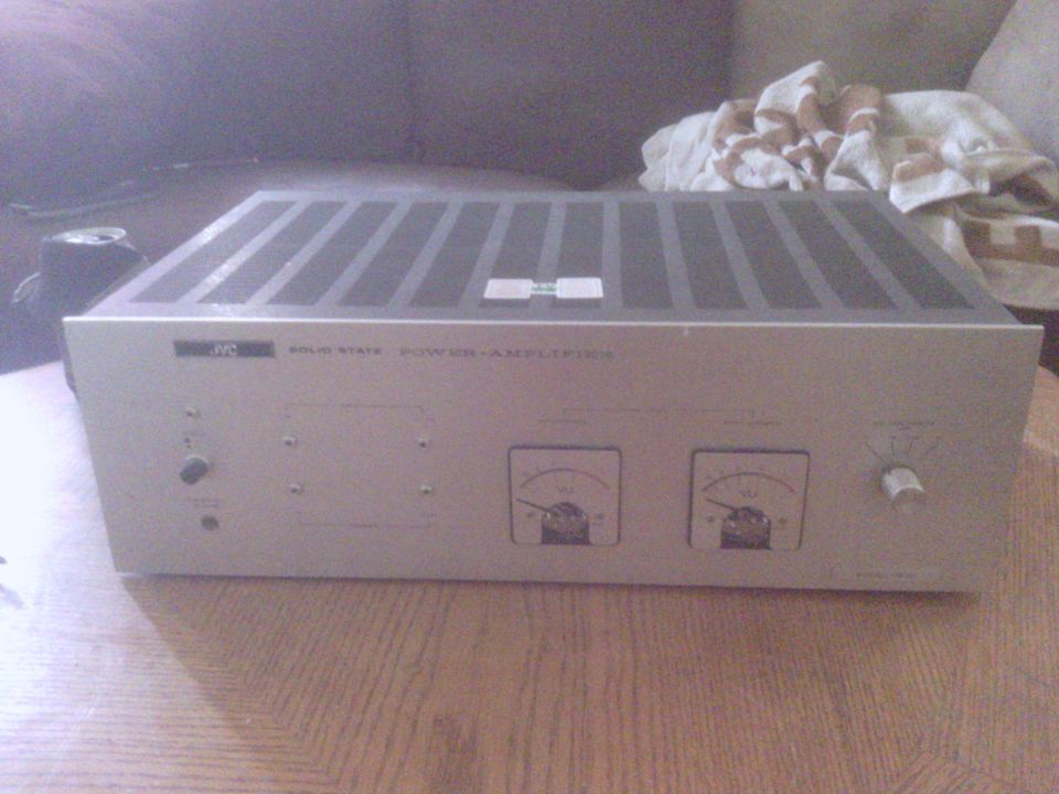 Silver JVC solid state power amplifier with two VU meters and a dial.