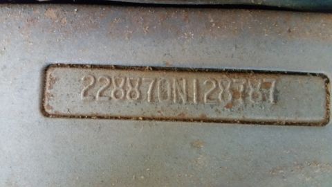 2015 Chevrolet new - A close-up view shows a metal plate with the stamped identification number "228870N1287857" against a textured, weathered surface.