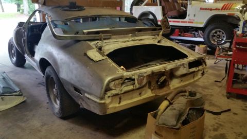 2015 Chevrolet new - The rear three-quarter view of a vintage car undergoing restoration. The trunk is open, revealing the interior, and the body shows signs of…