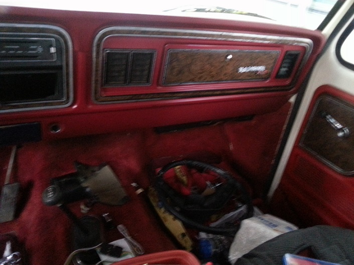 Interior view of a 1978 Ford Bronco showing the dashboard, gear shifter, and floor.