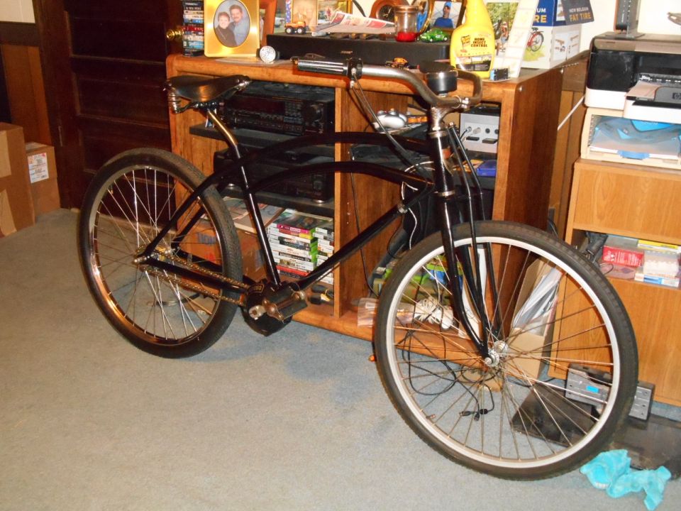 Black cruiser bicycle parked indoors