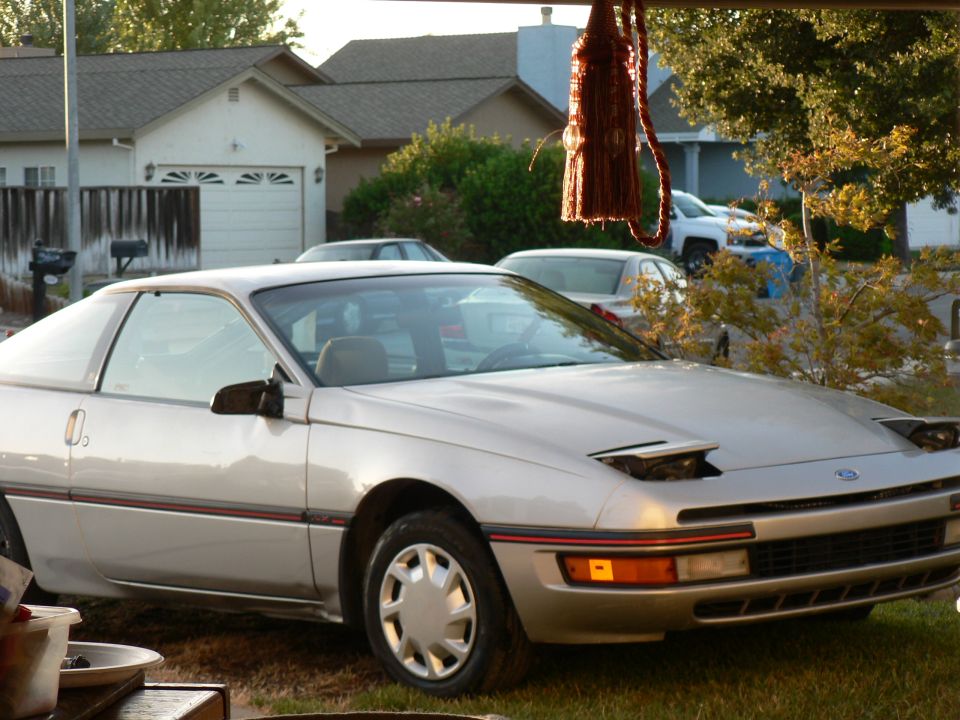Silver 1991 Ford Probe parked in a driveway.