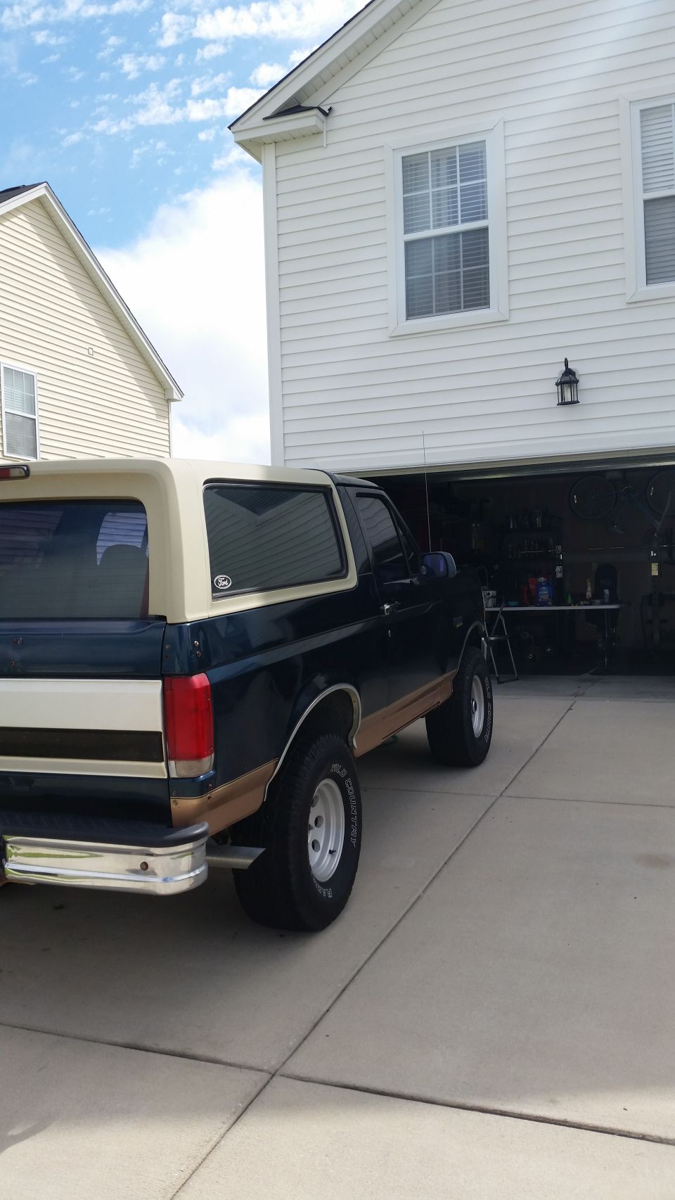 1995 Ford Bronco rear passenger side view, parked in driveway.