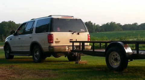2002 Ford Expedition - The rear view of a 2002 Ford Expedition is shown, hitched to a utility trailer.