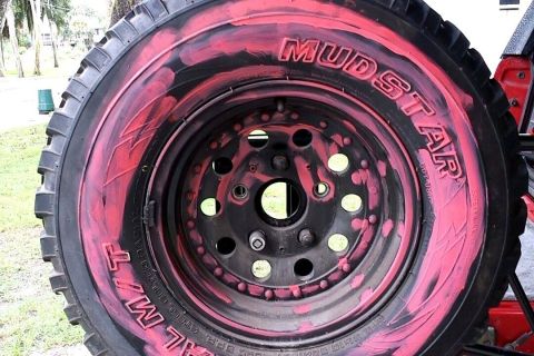 1995 Ford Bronco - Custom painted Mud Star tire and wheel assembly, likely for off-road use.