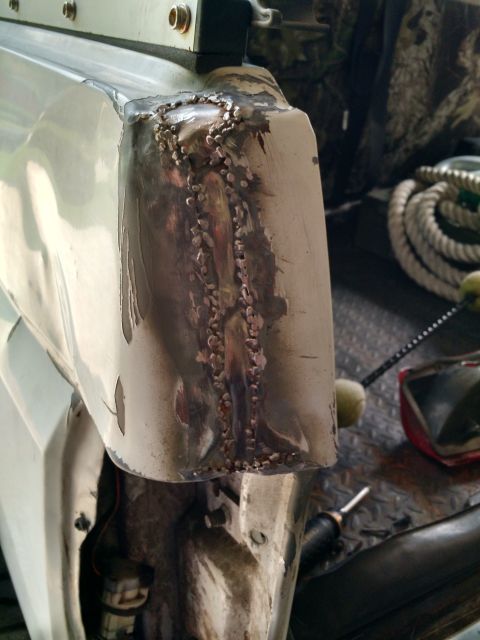 1992 Ford Bronco - This photo shows a vehicle's body panel that has been repaired with welding, indicating bodywork has been done.