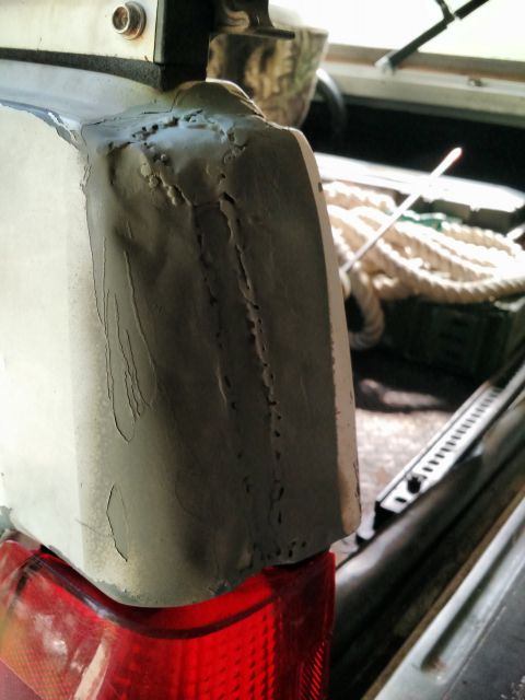 1992 Ford Bronco - Body panel repair work shown with bondo application and visible damage.