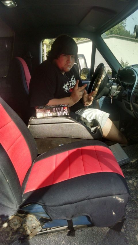 1996 Ford Bronco - Driver poses inside a 1996 Ford Bronco with red and black seat covers.