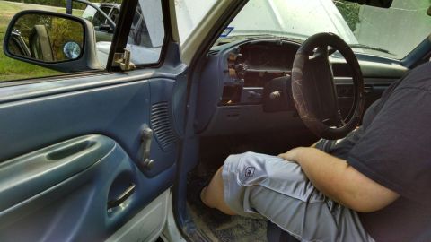 1996 Ford Bronco - Interior view of a 1996 Ford Bronco, showing the dashboard and driver's side door.
