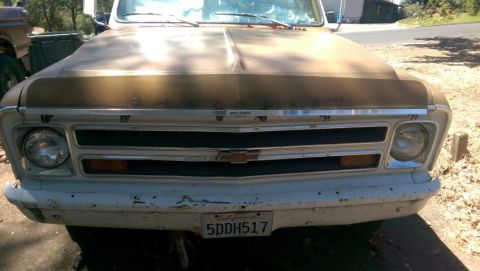 1968 Chevrolet C/K Pickup - Front view of a weathered Chevrolet pickup truck with a distinctive grille and headlights.
