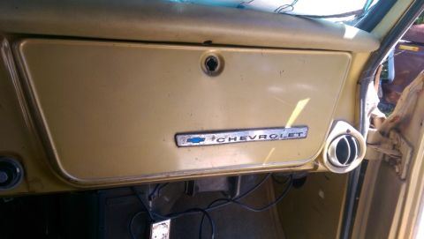 1968 Chevrolet C/K Pickup - Close-up of the dashboard in a 1968 Chevrolet C/K Pickup, showing the Chevrolet emblem.