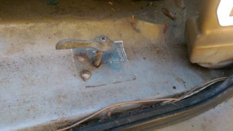 1968 Chevrolet C/K Pickup - A close-up view of a vehicle's interior shows a worn door latch and a partially visible sticker with the word "TRAVEL".