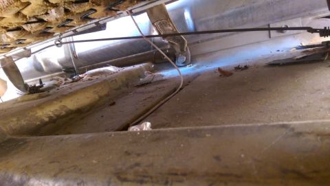 1968 Chevrolet C/K Pickup - Underside view of a 1968 Chevrolet C/K Pickup interior, revealing seat springs and a dirty floor pan.