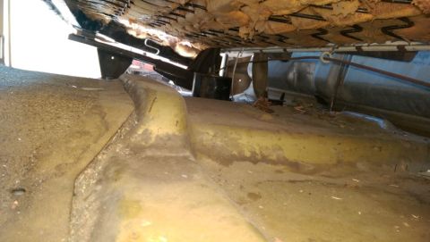 1968 Chevrolet C/K Pickup - The underside of a vehicle seat reveals worn springs and a dirty floor pan, with a Supermotors.net logo in the corner.
